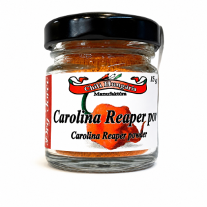 Glass jar with black lid containing orange Carolina Reaper pepper powder; label reads 'Carolina Reaper powder' with heart graphic.