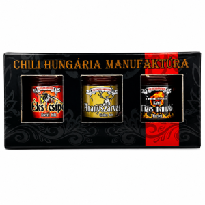 Three jars of chili sauce in a black gift box labeled 'Chili Hungária Manufaktúra' with orange text and decorative patterns (assortment set).